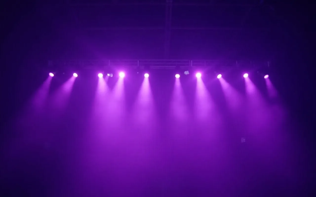 Stage lighting beams cutting through haze